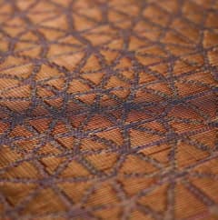 Woven copper and bronze surface, warm colorway detail